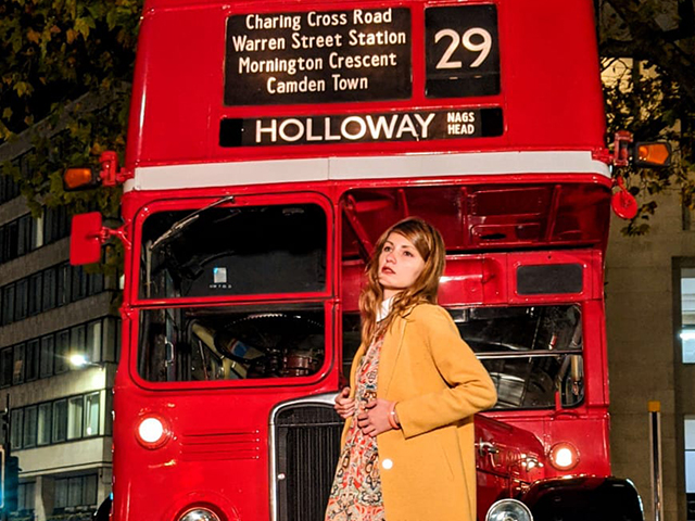 The swinging 60's with models and a vintage RT bus in London at night