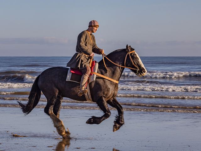Horses and historic riders on the beach